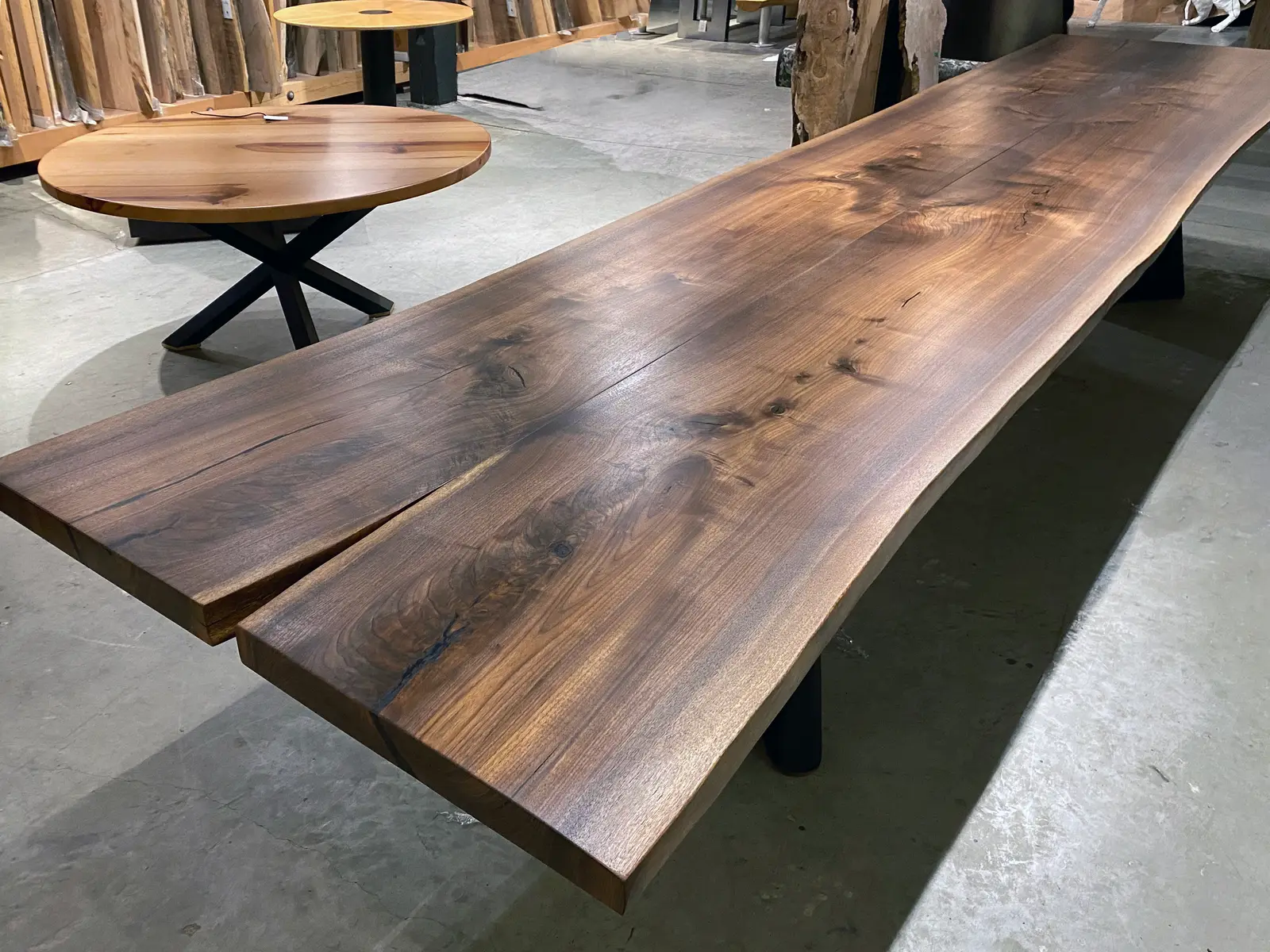 The Boomerang table — seventeen feet of continuous live-edge walnut in the Chapel Arts shop