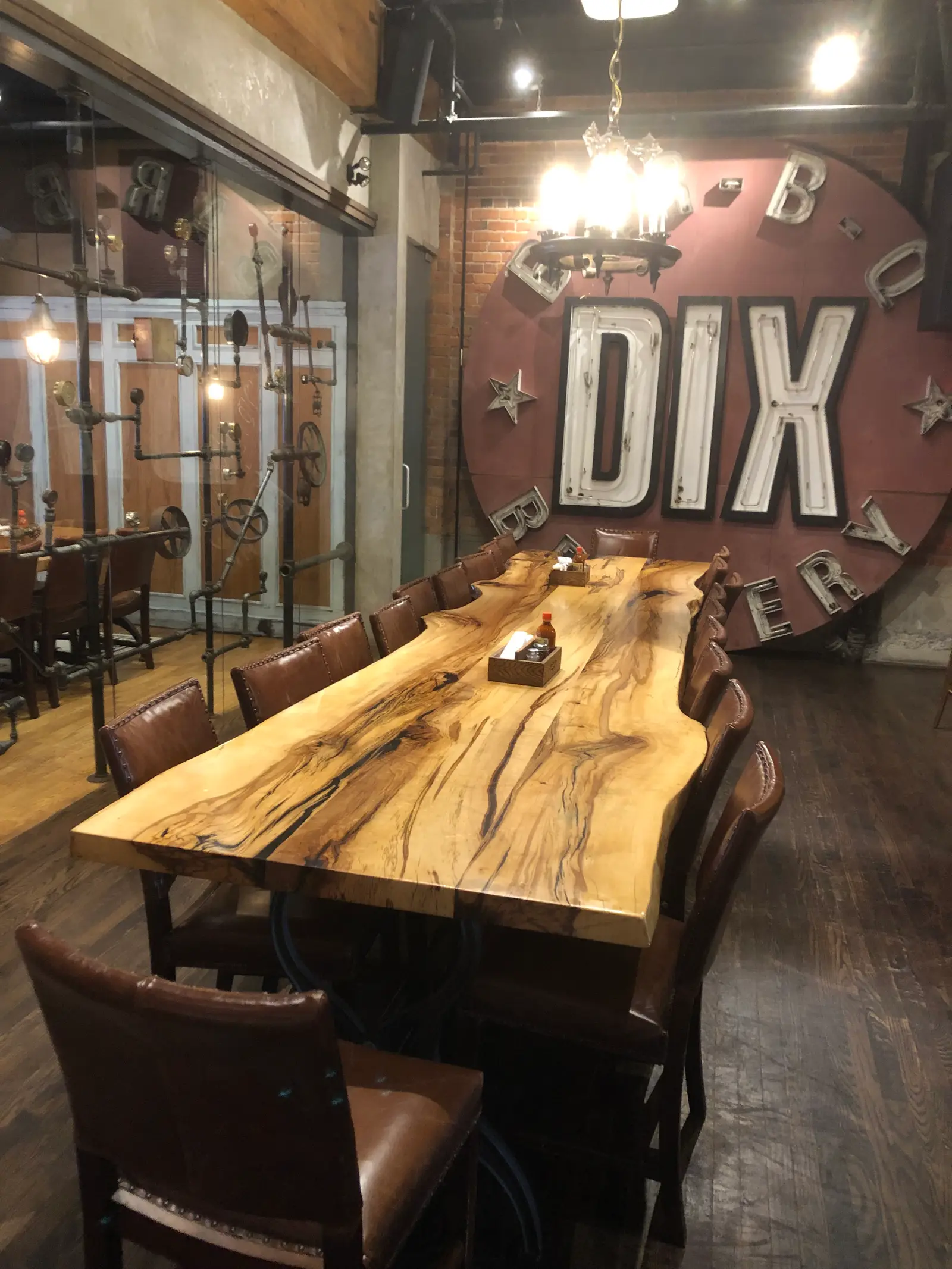 Live-edge spalted maple communal table with leather chairs at a brewery restaurant