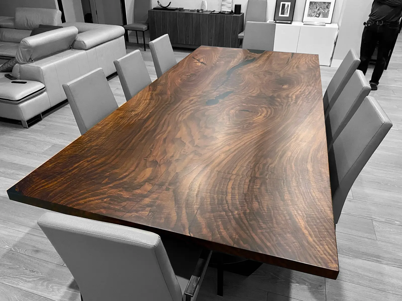 Richly figured, book-matched walnut dining table installed in a home