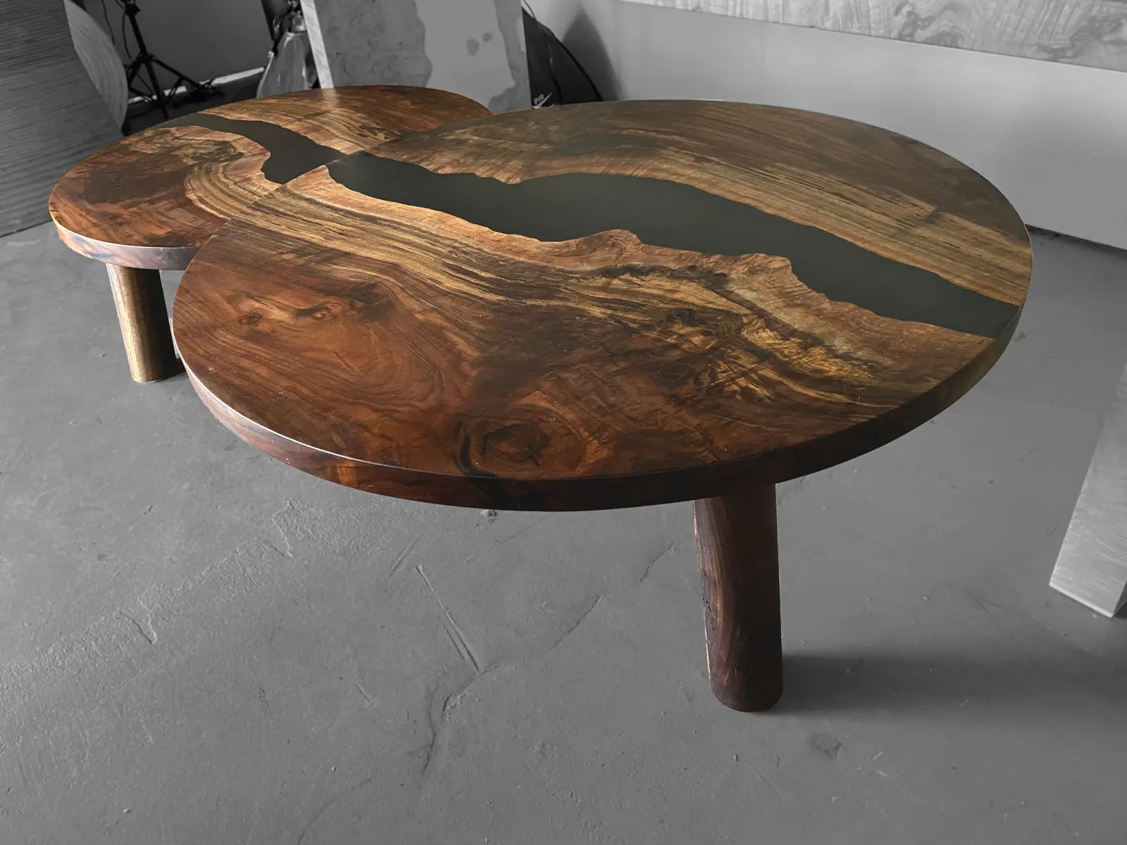 Nesting round walnut coffee tables with cast black resin rivers