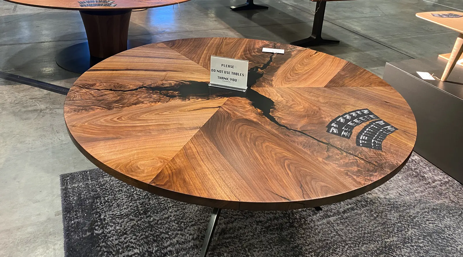 Round dining table of book-matched black walnut segments with resin-stabilized checks