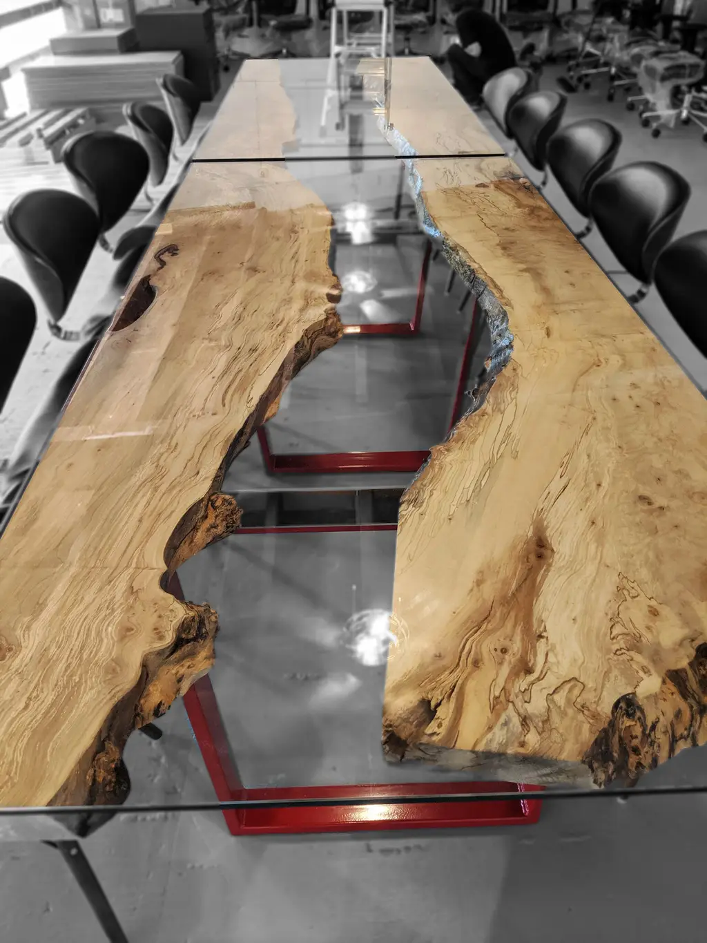 Glass-topped spalted maple boardroom table on a red steel base