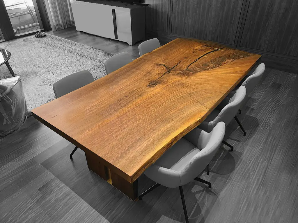 Live-edge walnut boardroom table with brass detailing